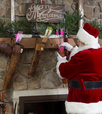 Santa Clause hanging archery stockings with gifts for good little boys and girls